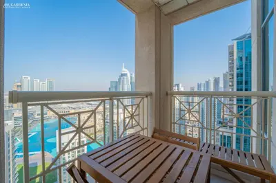 a balcony with a bench and a view of a city at 29 Boulevard-Burj Khalifa View-Downtown Dubai-Lit Apartment in Dubai