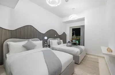 a hotel room with two beds and a window at Luxe Living At Damac heights - Dubai Marina - Marina & Sea Views in Dubai