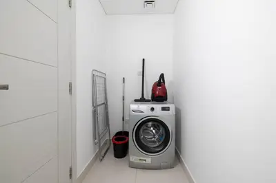 a washer and dryer in a white room at Luxe Living At Damac heights - Dubai Marina - Marina & Sea Views in Dubai