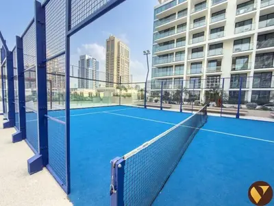 a tennis court in front of a building at Vogue JVC Binghatti Phoenix near Circle Mall, Studio Apartment with Balcony and Access to all Amenities in Dubai