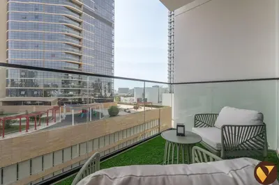 a balcony with a view of a tall building at Vogue JVC Binghatti Phoenix near Circle Mall, Studio Apartment with Balcony and Access to all Amenities in Dubai