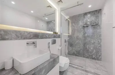 a white bathroom with a sink and a toilet at Luxury 1BR near Burj Khalifa Business Bay Free Parking in Dubai