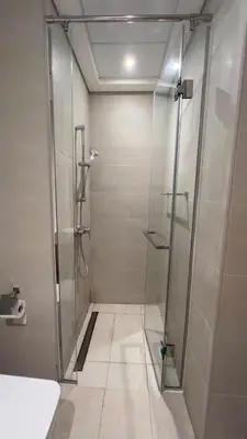 a shower with a glass door in a bathroom at Luxury Studio big Balcony in Dubai