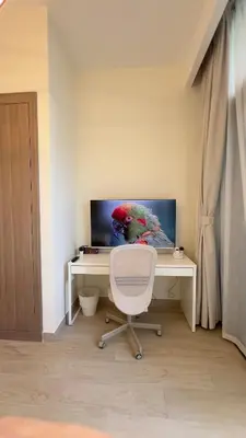 a desk with a white chair and a computer monitor at Luxury Studio big Balcony in Dubai
