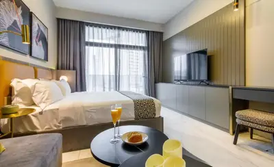 a bedroom with a bed and a table with drinks on it at Mag318 downtown Luxury-5 Minutes walk to Burj&mall in Dubai