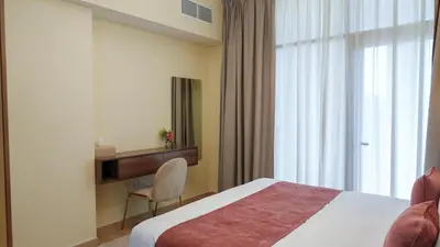 a hotel room with a bed and a window at Stunning 2BR Canal & Burj Khalifa Partial View 4 in Dubai