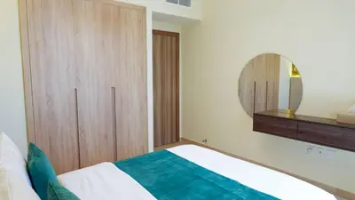 a bedroom with a bed and a mirror at Stunning 2BR Canal & Burj Khalifa Partial View 4 in Dubai