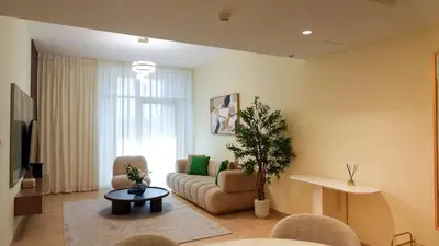 a living room with a couch and a table at Modern 2BR City Skyline View 6 in Dubai