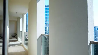 a hallway with a view of a tall building at Modern 2BR City Skyline View 6 in Dubai