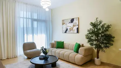 a living room with a couch and a chair at Modern 2BR City Skyline View 6 in Dubai