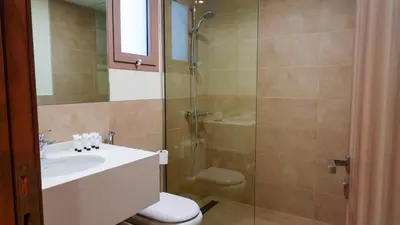 a bathroom with a shower and a sink and a toilet at Modern 2BR City Skyline View 6 in Dubai