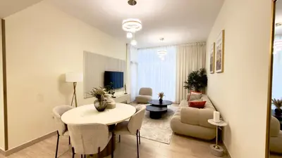 a living room with a table and a couch at Stunning 2BR Canal & City Skyline View 7 in Dubai