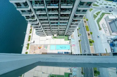 an overhead view of a building with a pool of water at Stunning 2BR Canal & City Skyline View 7 in Dubai