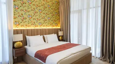 a bedroom with a bed and a painting on the wall at Elegant 2BR Canal & Burj Khalifa Partial View 5 in Dubai