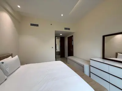 a bedroom with a bed and a dresser and a mirror at Comfort Focused 1BR Laya JVC in Dubai