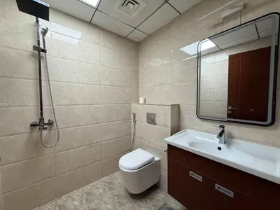 a bathroom with a toilet and a sink and a shower at Comfort Focused 1BR Laya JVC in Dubai