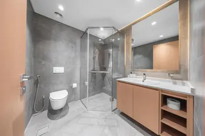 a bathroom with a shower and a toilet and a sink at Brand-New Elegant Stay Premium Amenities JVT in Dubai