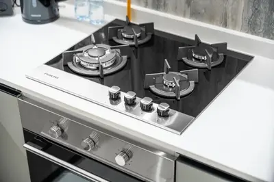 a stove top with four pots and pans on it at Brand-New Elegant Stay Premium Amenities JVT in Dubai