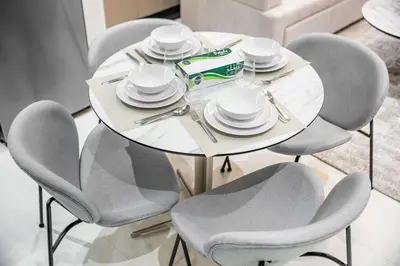 a white table with chairs and plates on it at Brand-New Elegant Stay & Premium Amenities in JVT in Dubai