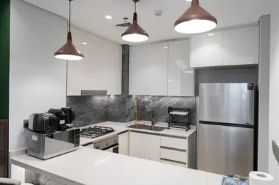 a kitchen with a stove and a refrigerator at Luxury 1BHK Apartment Nobles Tower, Business Bay in Dubai