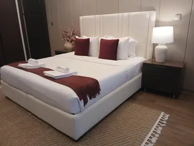 a large white bed in a hotel room at Luxury 1BHK Apartment Nobles Tower, Business Bay in Dubai