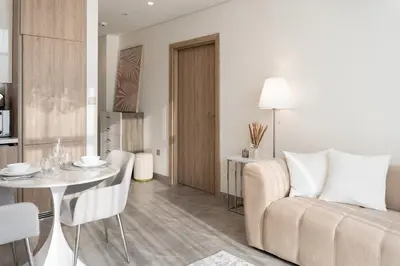 a living room with a couch and a table at 1BR - Peninsula One in Dubai