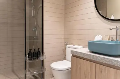 a bathroom with a toilet and a sink at 1BR - Peninsula One in Dubai