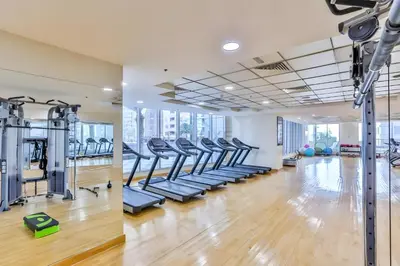 a gym with treadmills and elliptical machines at 2BR, Seaside Serenity, Sea View - Torch Tower, Dubai Marina by Deluxe Holiday Homes in Dubai