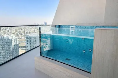 a hot tub on a balcony with a view of a city at Premium 1BR W Private Pool Binghatti Royale in Dubai