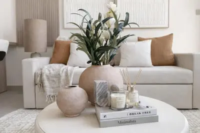 a living room with a couch and a table with a vase at Luxury 1BR Haven W Private Pool - Binghatti Royale in Dubai