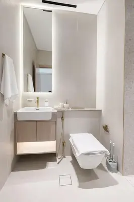 a bathroom with a sink and a toilet and a mirror at Luxury 1BR Haven W Private Pool - Binghatti Royale in Dubai