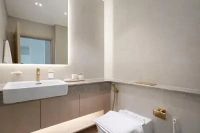 a bathroom with a white sink and a mirror at Luxury 1BR Haven W Private Pool - Binghatti Royale in Dubai