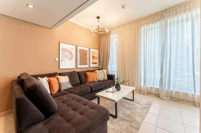 a living room with a couch and a table at HAVN - 1 Bedroom in Downtown Dubai in Dubai