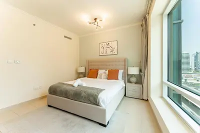a bedroom with a bed and a window at HAVN - 1 Bedroom in Downtown Dubai in Dubai