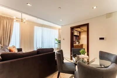 a living room with a couch and chairs and a table at HAVN - 1 Bedroom in Downtown Dubai in Dubai