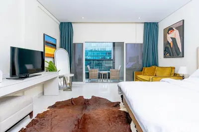 a hotel room with a bed and a tv at Nasma Luxury stays - Executive stay with hotel facilities in Dubai