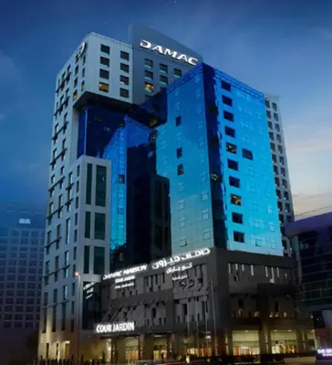 a santander building in a city at night at Nasma Luxury stays - Executive stay with hotel facilities in Dubai