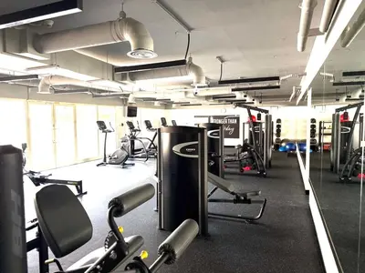 a gym with lots of treadmills and machines at Elegant apartment in a prime location in Dubai