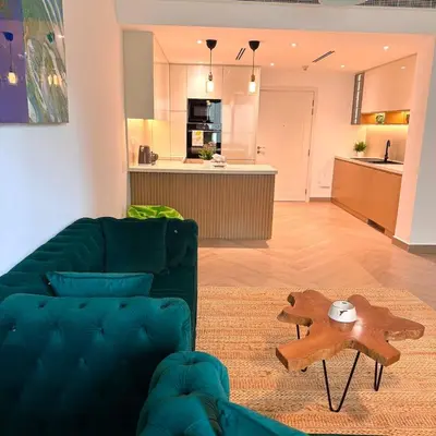 a living room with a couch and a table at Elegant apartment in a prime location in Dubai