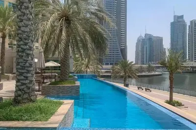 a swimming pool with a view of the city at Bright, modern flat on the Marina Promenade in Dubai