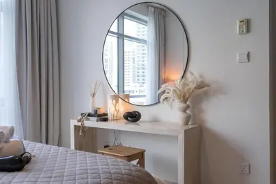 a bedroom with a large mirror and a bed at Bright, modern flat on the Marina Promenade in Dubai