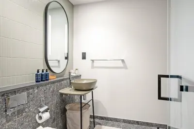 a bathroom with a sink and a mirror at VayK - Luxury 1 BD with Panoramic Canal Views in Dubai