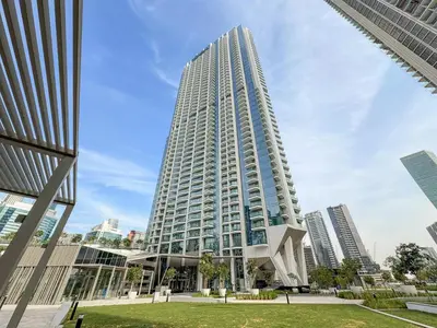 a tall building with a sculpture in front of it at VayK - Luxury 1 BD with Panoramic Canal Views in Dubai