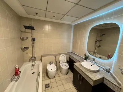 a bathroom with a tub and a toilet and a sink at Spacious 2BR Apartment-Marina Walk Luxury Stay-Enjoy Dubai Marina Views in Dubai