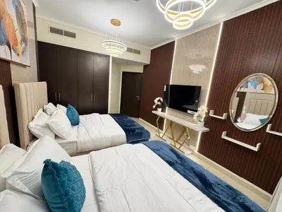 a hotel room with two beds and a mirror at Spacious 2BR Apartment-Marina Walk Luxury Stay-Enjoy Dubai Marina Views in Dubai