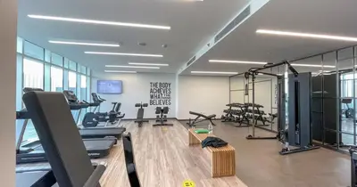 a gym with several treadmills and exercise bikes at Luxury 3BHK & Maid Sea View & Private Beach in Sabkhah