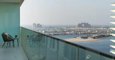 a balcony with chairs and a view of a beach at Luxury 3BHK & Maid Sea View & Private Beach in Sabkhah