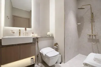 a bathroom with a toilet and a sink and a shower at Serene 1BR Retreat W Private Pool Binghatti Royale in Dubai