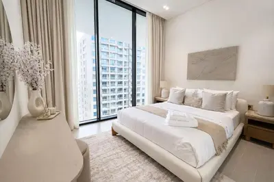 a white bedroom with a large bed and large windows at Serene 1BR Retreat W Private Pool Binghatti Royale in Dubai