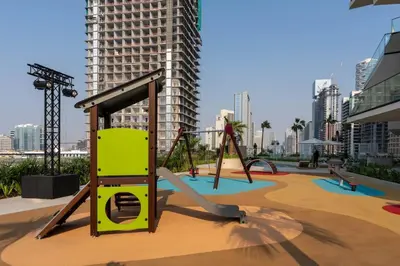 an empty playground in a city with tall buildings at Serene 1BR Retreat W Private Pool Binghatti Royale in Dubai